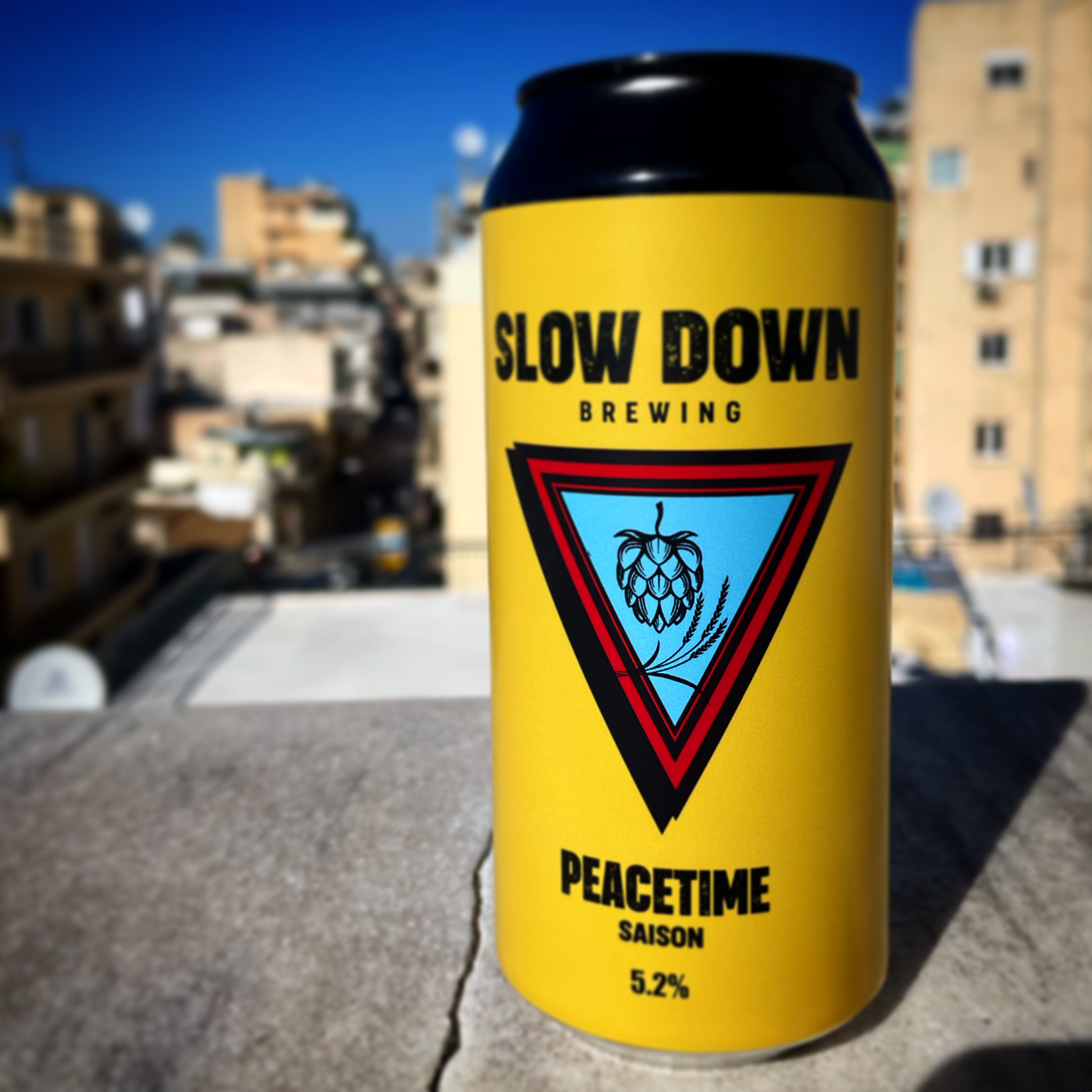 A can of Peacetime Saison by Slow Down Brewing